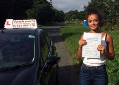 Latifa with driving test pass certificate after taking lessons in North Wales