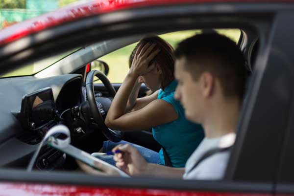 Girl in car with instructor after  failed a driving test 