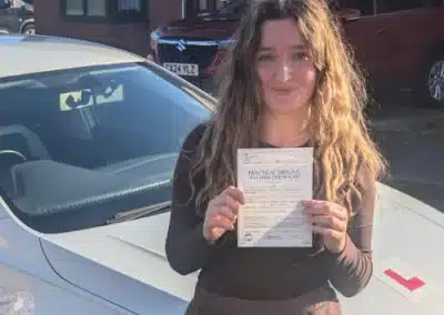A newly passed girl celebrating passing her driving test in Rhyl