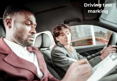 An examiner marking a driving test