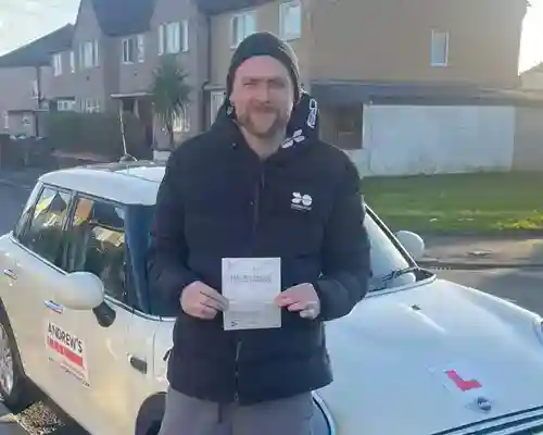 A new driver with an automatic driving instructors car and test pass certificate