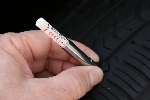 Using a tyre tread gauge