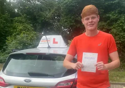 A learner with Pass Certificate after his driving test at Wrexham Driving Test Centre