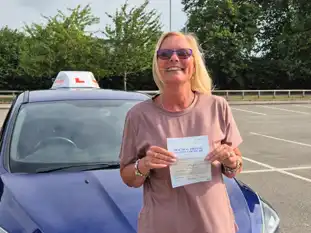 A new driver posing with a pass certificate in Wrexham