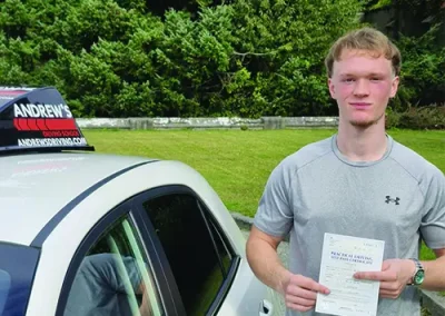 A young man with a driving test pass certificate