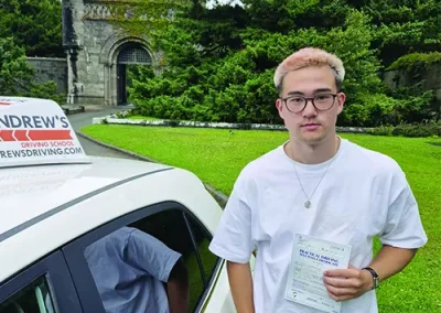 A young man with a driving test pass certificate