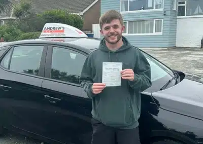 Steve Owens with his driving test certificate and instructors car, outside a house