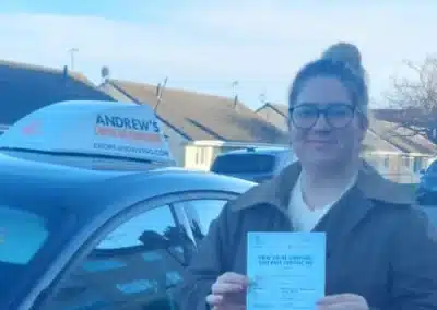Young Lady with driving certificate next to Peters car in Llandudno