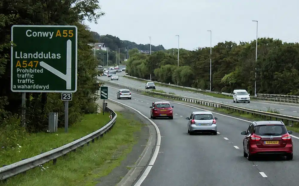 A55 Junction 23 llanddulas dual carriageway with traffic and road signs near Llanddulas, illustrating A55 restrictions for learners on a major road