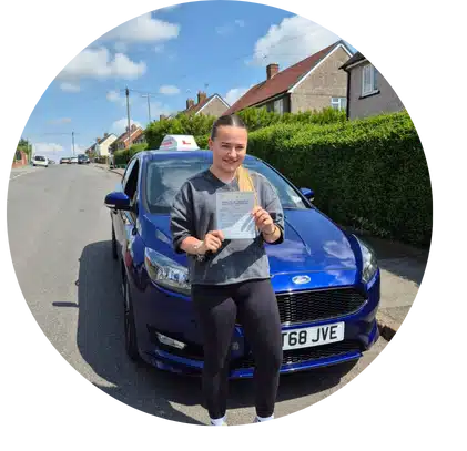 Learner driver holding a driving test pass certificate beside an Andrew’s driving school car in Telford
