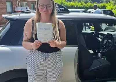 A new driver at Barnsley Driving Test Centre holding her pass certificate
