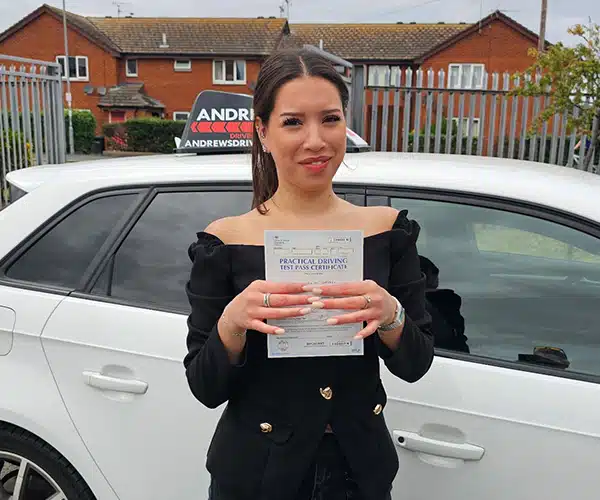 Amelia Davies celebrates passing her driving test first time in Rhyl with instructor John Hewitt from Andrew's Driving School.