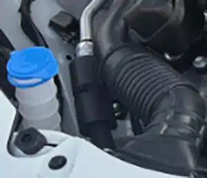 Suzuki Swift screen wash reservoir with blue filler cap