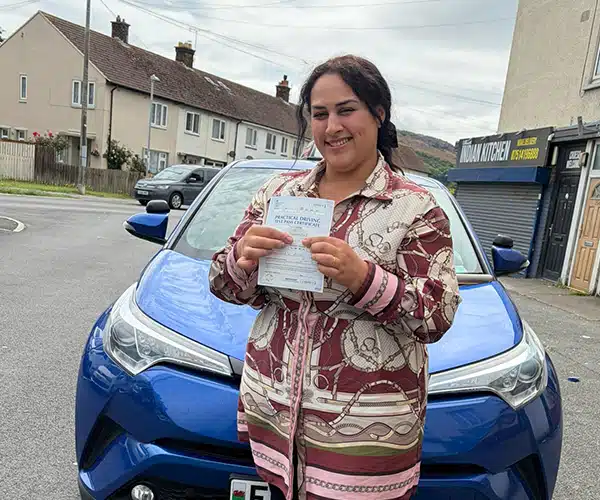 Shulova from Llandudno celebrates passing her automatic driving test in Rhyl with instructor Fiona from Andrew's Driving School.