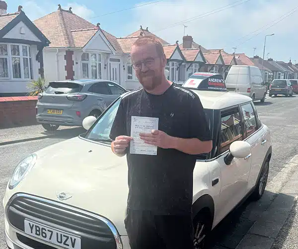 Chris celebrating a driving test pass in Rhyl with Andrew's Driving School.