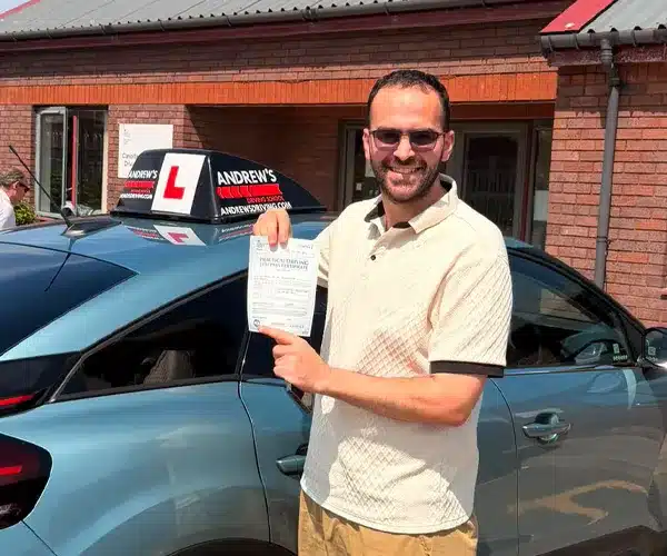 Dr Khalil celebrating a driving test pass in Rhyl with Andrew's Driving School.