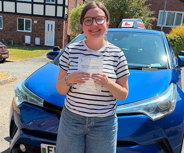 Kirsty celebrating a driving test pass with Andrew's Driving School.