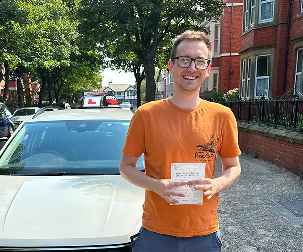 Matthew after passing his driving test beside instructor Paul Singleton’s Volkswagen.