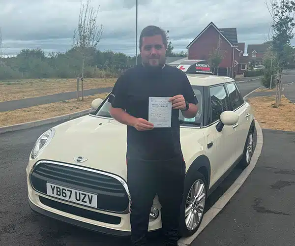 Nathan celebrating a driving test pass in Rhyl with Andrew's Driving School.