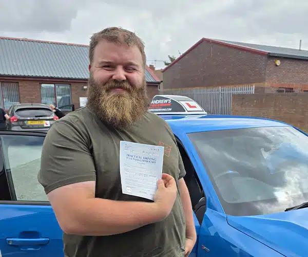 Stephen celebrating a driving test pass in Rhyl with Andrew's Driving School.