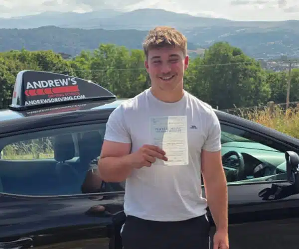 Toby celebrating a driving test pass in Llandudno with Andrew's Driving School.
