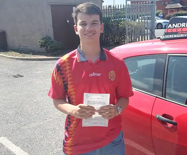 Alex celebrating a driving test pass in Rhyl with Andrew's Driving School.