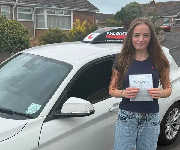 Alice celebrating a driving test pass with Andrew's Driving School.