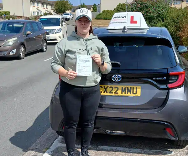 Amy celebrating a driving test pass with Andrew's Driving School.