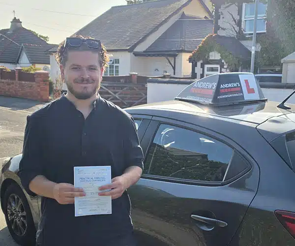 Brody in Prestatyn with Kim's automatic Mazda happy after passing his test in Rhyl