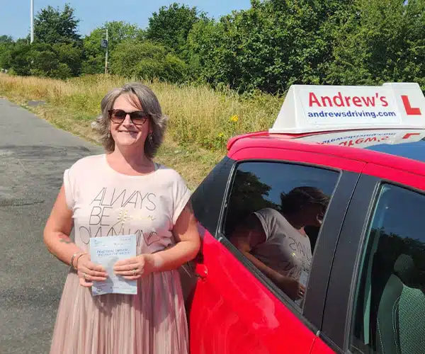 Emma celebrating a driving test pass with Andrew's Driving School.