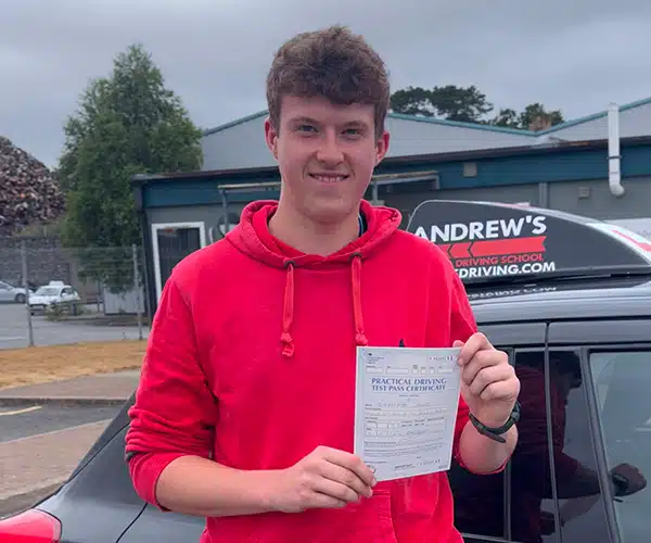 Guto celebrating a driving test pass in Bangor with Andrew's Driving School.