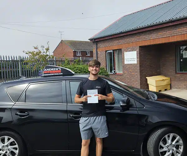 Hamish celebrating a driving test pass in Rhyl with Andrew's Driving School.