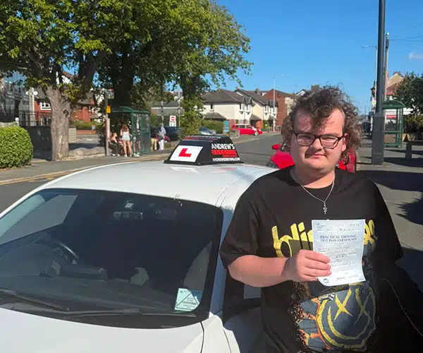 Harry celebrating a driving test pass in Rhyl with Andrew's Driving School.