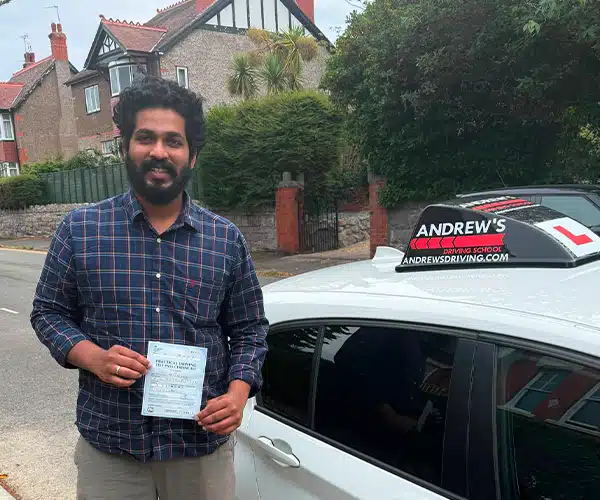 Jackson celebrating a driving test pass in Colwyn Bay with Andrew's Driving School.
