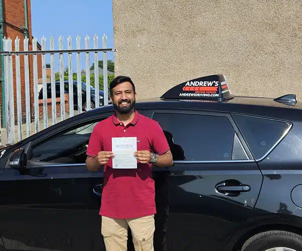 Jerry celebrating a driving test pass in Rhyl with Andrew's Driving School.