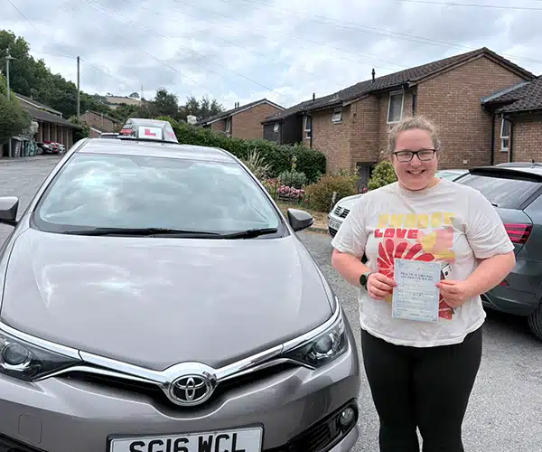 Jessica celebrating a driving test pass in Rhyl with Andrew's Driving School.