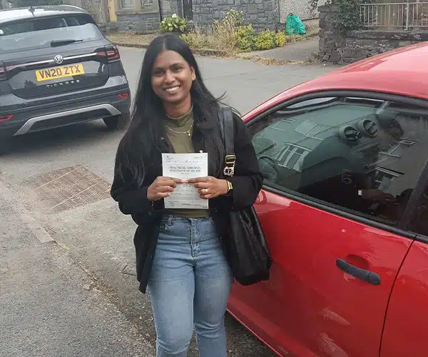 Lekshmi celebrating a driving test pass in Rhyl with Andrew's Driving School.