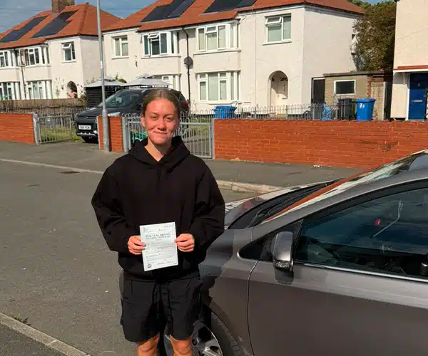 Lexi celebrating a driving test pass in Abergele with Andrew's Driving School.