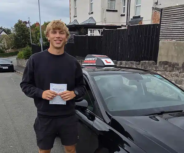 Matthew celebrating a driving test pass in Llandudno with Andrew's Driving School.