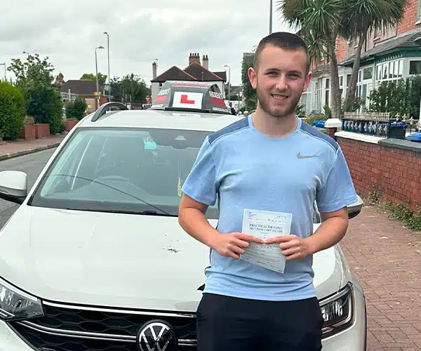 McCarthy celebrating a driving test pass in Rhyl with Andrew's Driving School.