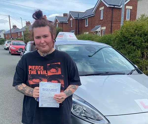 Melissa celebrating a driving test pass in Wrexham with Andrew's Driving School.