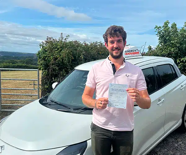 Oliver celebrating a driving test pass in Bangor with Andrew's Driving School.