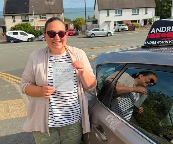 Sarah celebrating a driving test pass in Rhyl with Andrew's Driving School.