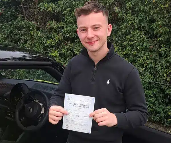 Alex in Janet's Mini in  Barnsley Driving Test Centre with his pass cerificate
