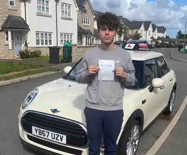 Ben with Jimmy Garland's automatic mini in Rhyl smiling after passing his driving test