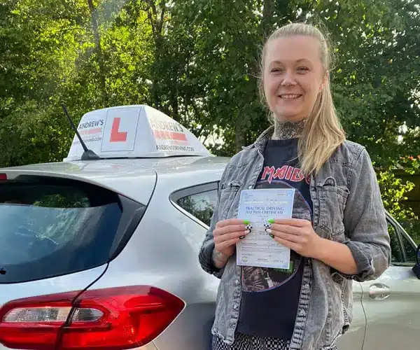 Chloe fro Gresford in Wrexham Driving Test Centre posing with her pass certificate by Karl's tuition Fiesta