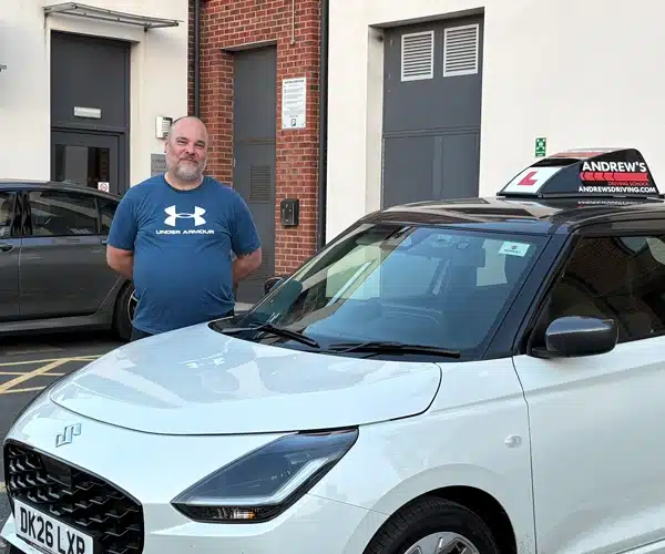 Neil Jones standing by his Andrew's Driving School car in Cadman Court Telford