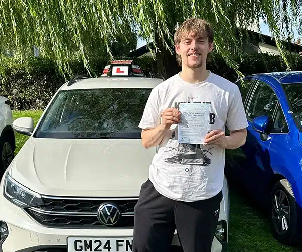 Daniel standing in front of Paul's tuition car in Rhyl after passing his driving test
