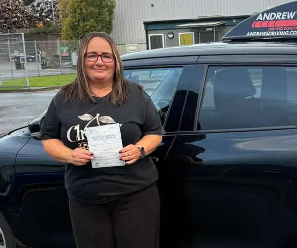 Louise Carter celebrating her driving test pass in Bangor after lessons with instructor Llinos Begley.