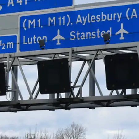 Smart motorway overhead signs showing speed limits and lane-control signals